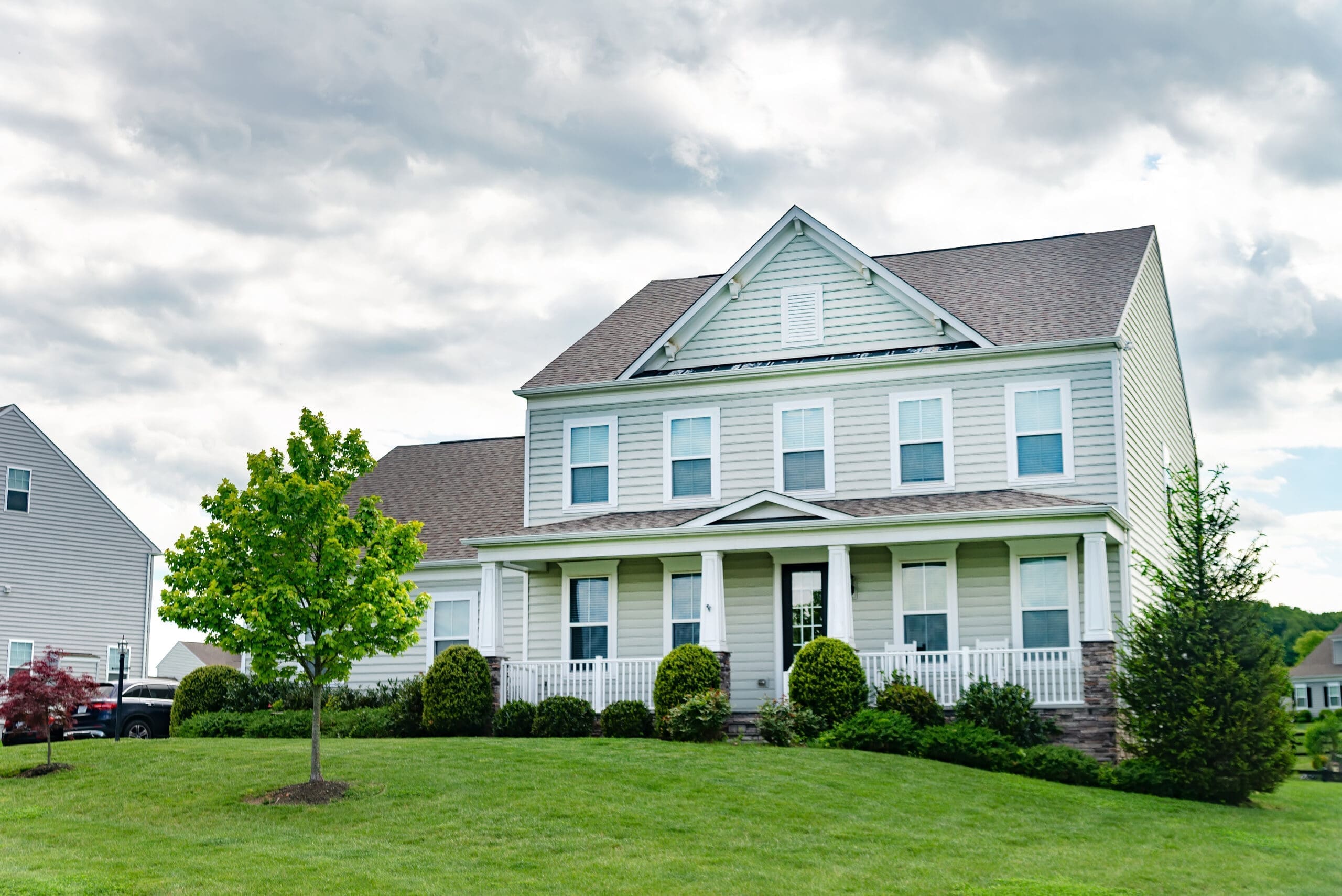 beautiful house with a well-kept and landscaped yard and lawn.